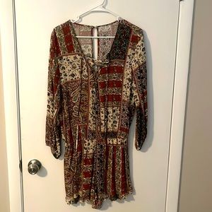 Elastic waist romper. Cross chest tie. Long sleeve with multicolor patterns.